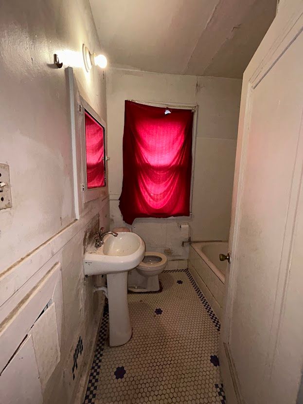 bathroom with tile patterned floors, a sink, a bath, and toilet