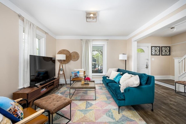 living room with baseboards, stairs, and wood finished floors
