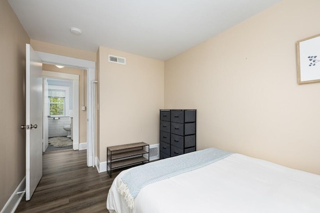 bedroom featuring visible vents, dark wood-style flooring, and baseboards