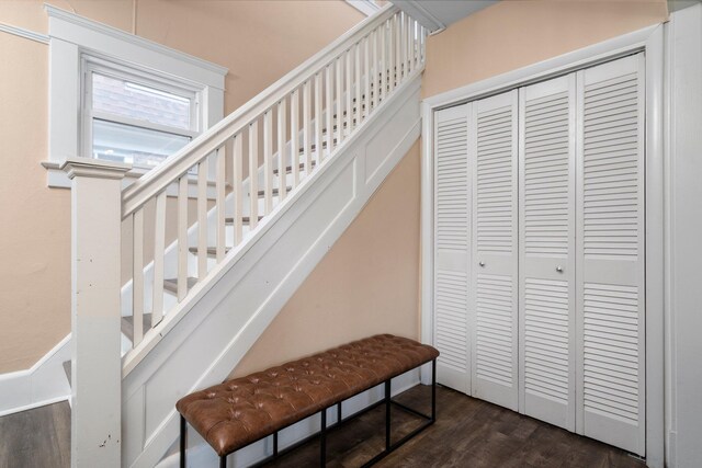 stairs featuring wood finished floors