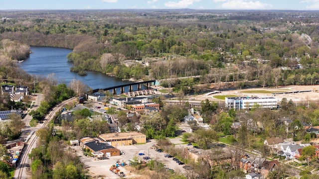 aerial view with a water view and a forest view