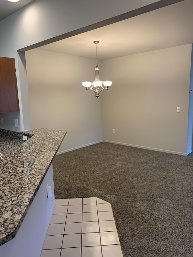 unfurnished dining area with baseboards, a chandelier, and light carpet