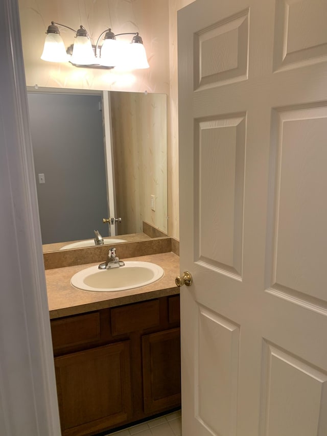 bathroom with tile patterned flooring and vanity