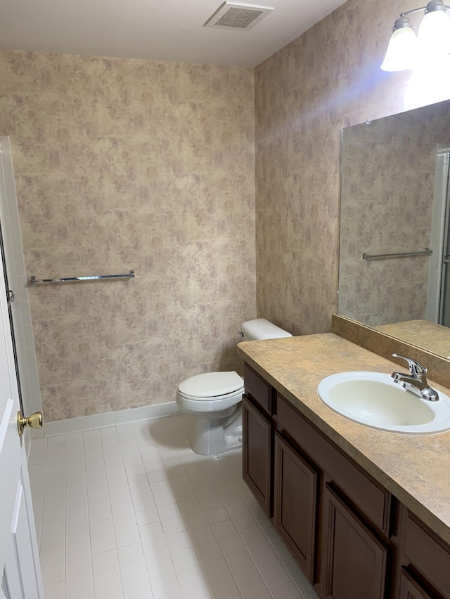 bathroom with visible vents, tile patterned floors, vanity, toilet, and wallpapered walls
