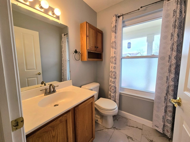 bathroom with vanity, marble finish floor, baseboards, and toilet