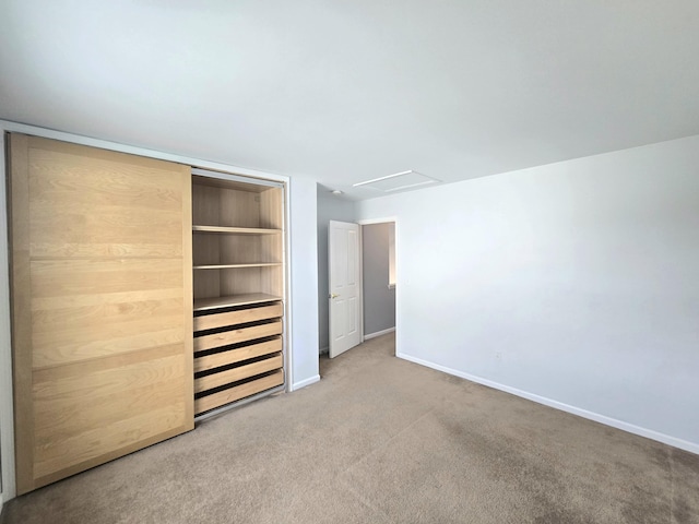 unfurnished bedroom with carpet flooring, baseboards, and a closet