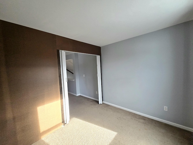carpeted spare room with baseboards