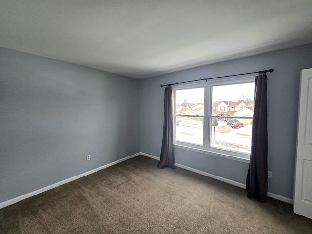 carpeted empty room with baseboards