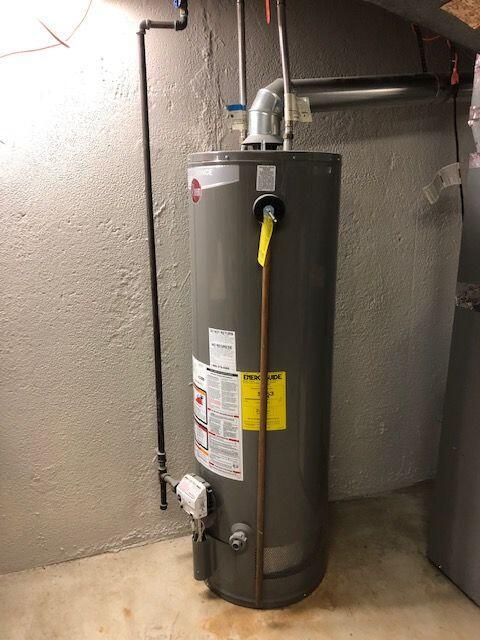 utility room featuring gas water heater