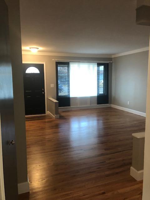 entryway featuring crown molding, baseboards, and wood finished floors