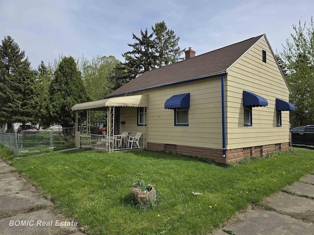 bungalow-style home featuring fence, roof with shingles, crawl space, a front yard, and a chimney