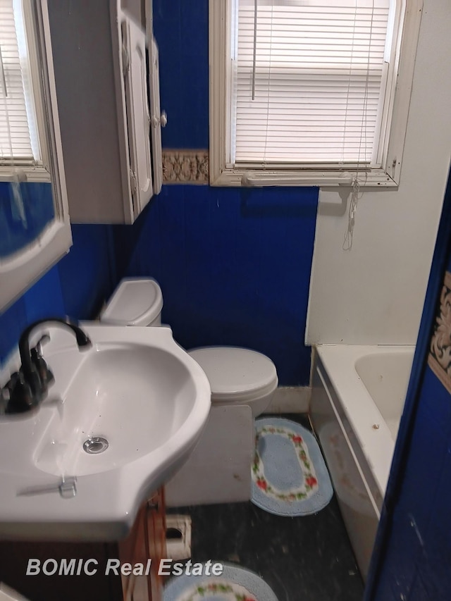 full bath featuring a sink, walk in shower, toilet, and a bathtub