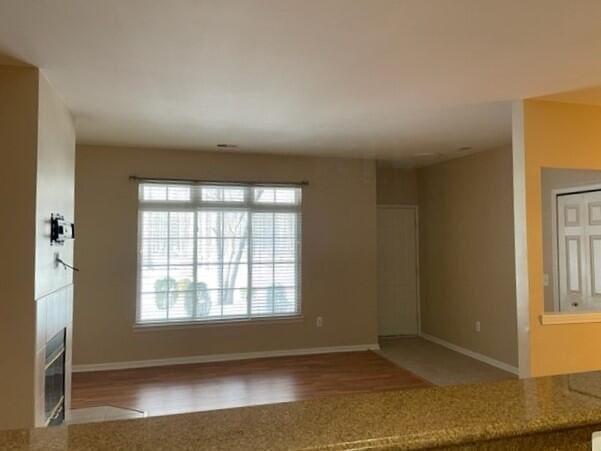 unfurnished room featuring baseboards and wood finished floors