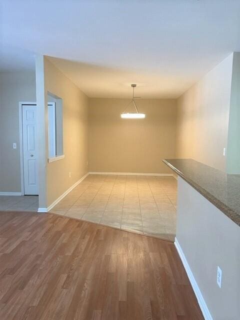 interior space featuring light wood-style floors and baseboards