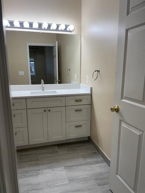 bathroom with baseboards and vanity