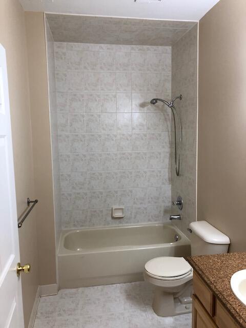 bathroom featuring shower / bath combination, toilet, and vanity
