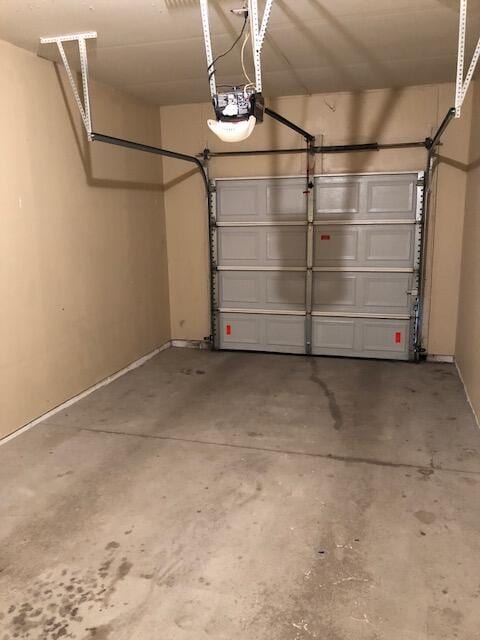 garage featuring baseboards and a garage door opener
