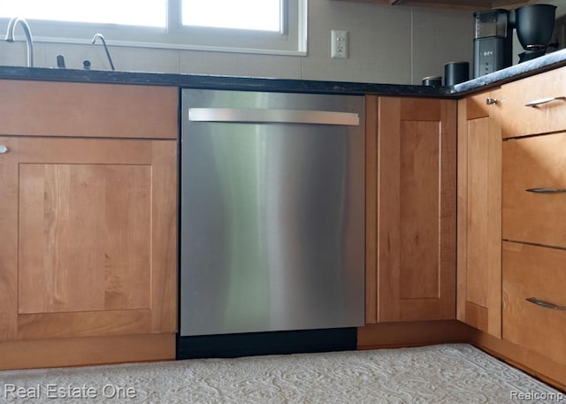 room details featuring a sink, dark countertops, and dishwasher