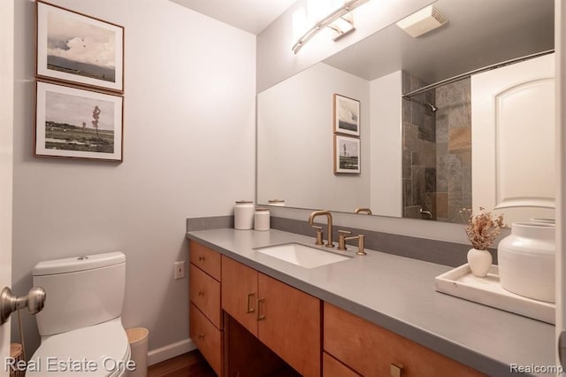 full bathroom with vanity, visible vents, toilet, baseboards, and walk in shower