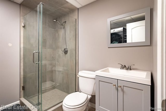 full bath featuring vanity, baseboards, toilet, and a shower stall