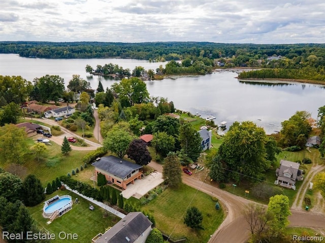 drone / aerial view with a water view and a view of trees