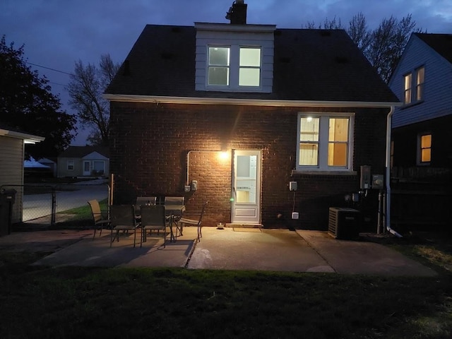 2528 Corbin St, Melvindale, MI 48122 - back of property with a chimney, a patio area, brick siding, cooling unit, and fence