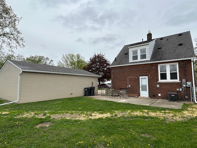 2528 Corbin St, Melvindale, MI 48122 - back of house with a chimney, central AC unit, brick siding, a yard, and a patio