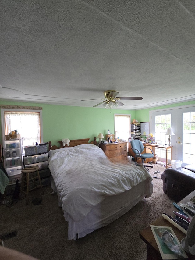 bedroom with french doors, carpet flooring, a textured ceiling, and ceiling fan