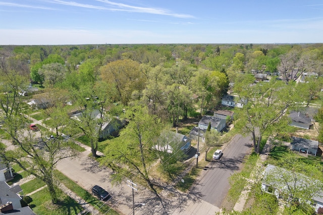 aerial overview of property's location with a forest and nearby suburban area