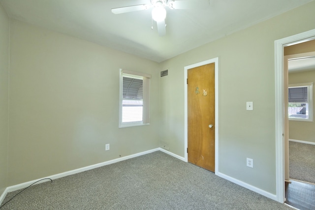 unfurnished bedroom featuring carpet, baseboards, and ceiling fan