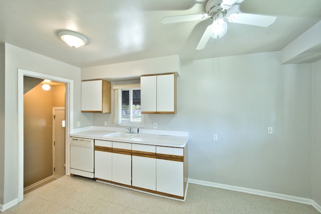 kitchen with white dishwasher, a sink, light countertops, baseboards, and a ceiling fan