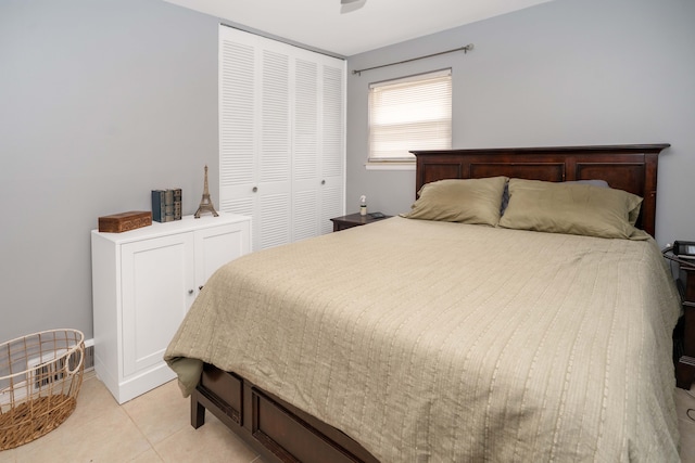 bedroom with light tile patterned floors and a closet