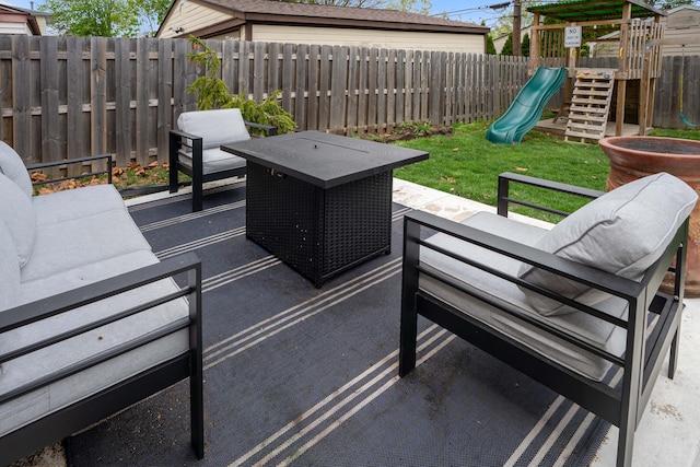 view of patio / terrace featuring a fenced backyard and a playground