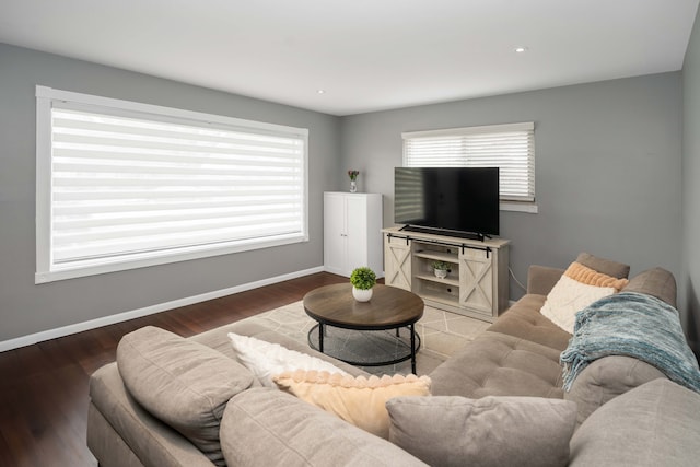 living area featuring baseboards and wood finished floors