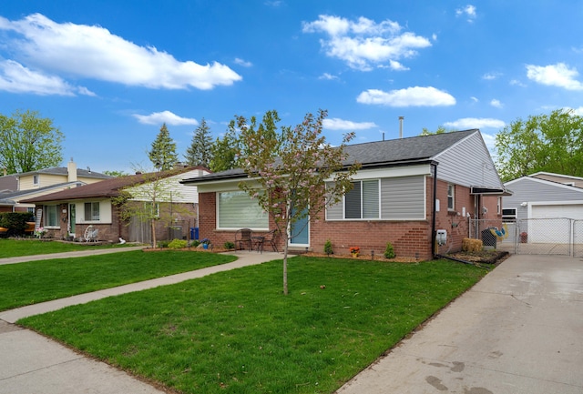view of front of property featuring a front yard, a gate, a detached garage, brick siding, and fence