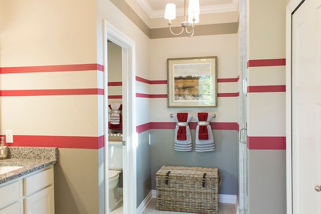 full bath with an inviting chandelier, vanity, toilet, baseboards, and ornamental molding
