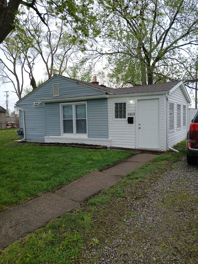 view of front of home with a front lawn and a chimney