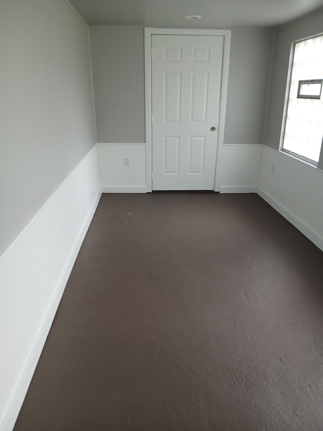 unfurnished room featuring dark colored carpet
