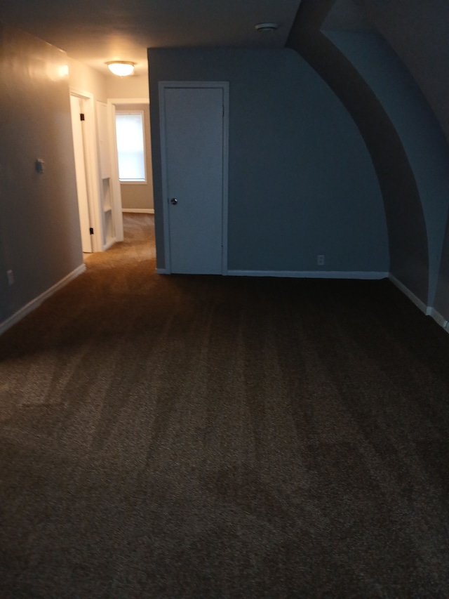 bonus room with carpet and baseboards