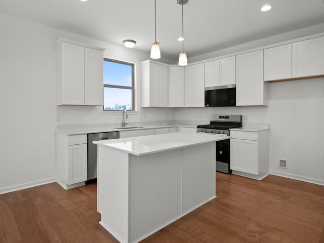 kitchen featuring recessed lighting, a sink, white cabinets, and stainless steel appliances