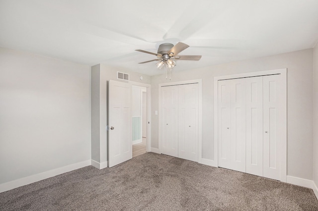 785 Maple Dr, Columbiaville, MI 48421 - unfurnished bedroom with baseboards, ceiling fan, visible vents, multiple closets, and carpet floors