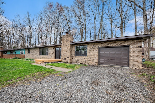 785 Maple Dr, Columbiaville, MI 48421 - mid-century home with an attached garage, brick siding, a chimney, and gravel driveway