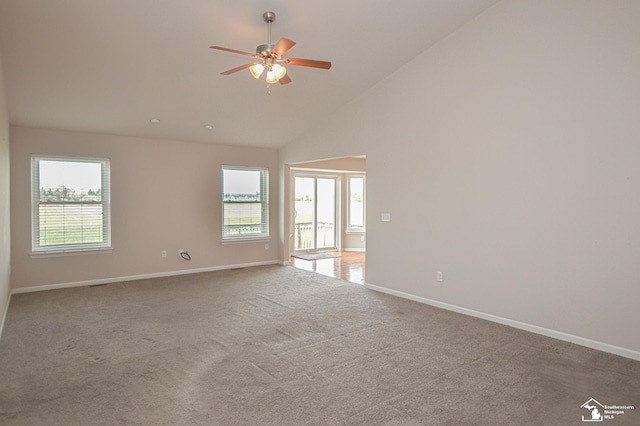 empty room featuring plenty of natural light and baseboards