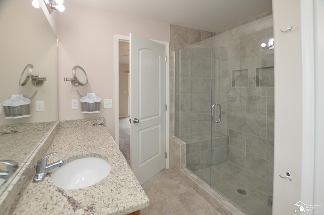 full bathroom featuring vanity, a shower stall, and tile patterned floors