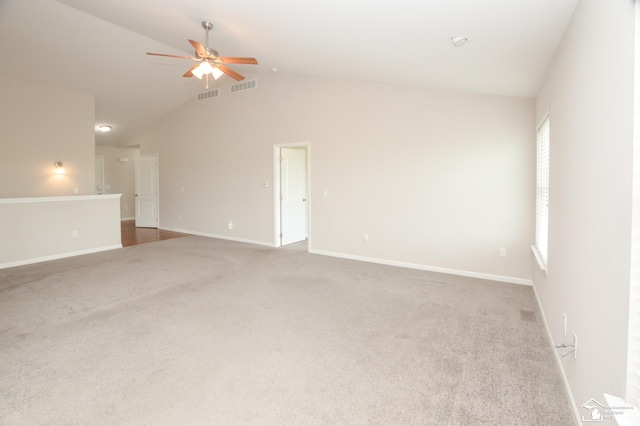 carpeted spare room featuring baseboards, a ceiling fan, lofted ceiling, and visible vents