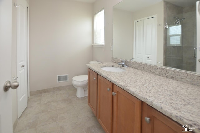 bathroom with visible vents, vanity, a healthy amount of sunlight, and a shower stall