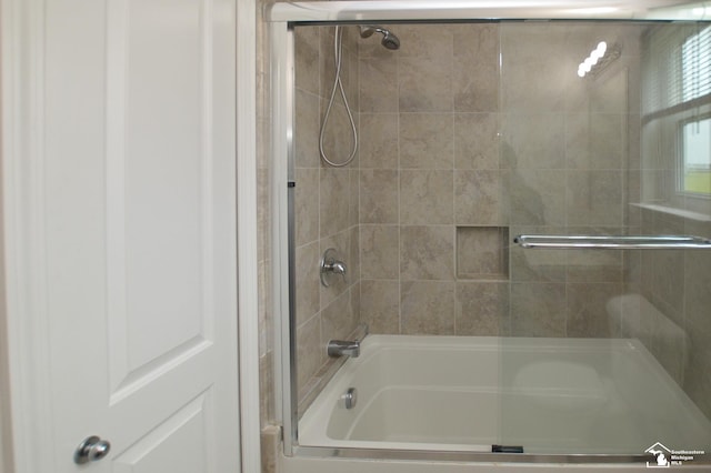 full bath featuring combined bath / shower with glass door