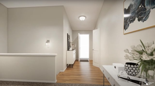 corridor featuring baseboards, an upstairs landing, and wood finished floors
