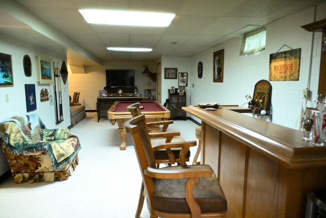 bar with a paneled ceiling, pool table, bar, and concrete block wall