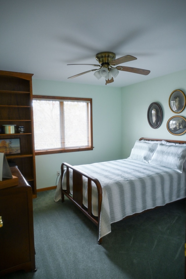 carpeted bedroom featuring baseboards and a ceiling fan